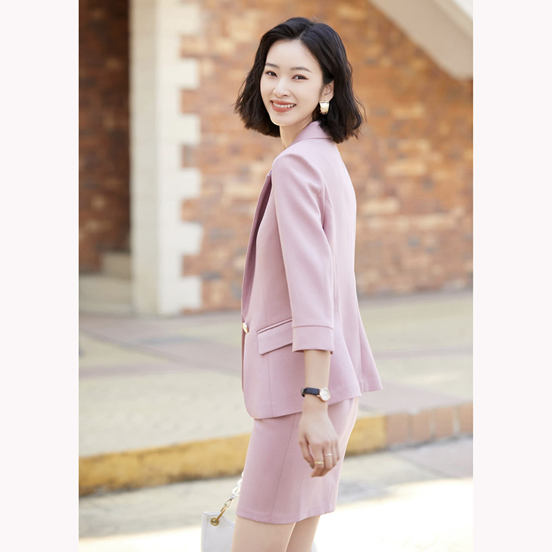 kudapy ชุดสูททำงานผู้หญิงสีเทา/สีชมพู แต่งกระดุมหนึ่งเม็ดแขนห้าส่วนพร้อมกระโปรง จุดเด่นของชุดนี้คือได้ลุคที่สดใส