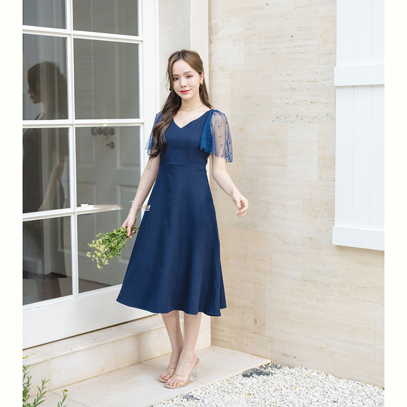 kudapy เดรสสั้นสีกรม ช่วงเสื้อเป็นคอวีกว้างแต่ไม่ลึกเกินไป ใส่แล้วทำให้ช่วงบนดูเพรียว ต่อด้วยเดรสกระโปรงบานพลิ้วๆ สาวหุ่นแบบไหนก็ใส่น่ารัก