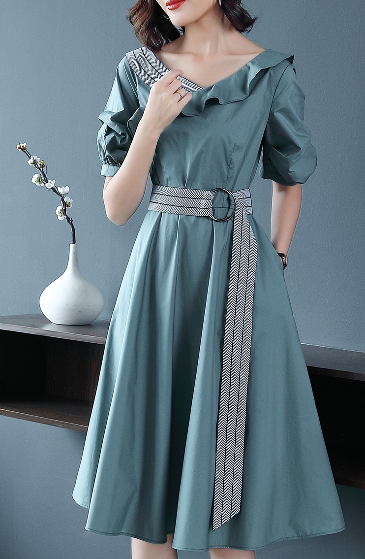 เดรสสั้นสีเขียว คอปาดกว้าง ผ้าคอตตอนผสม แต่งคอเสื้อข้างขวาลายเดียว มีเข็มขัดผูกเอวตามแบบ
