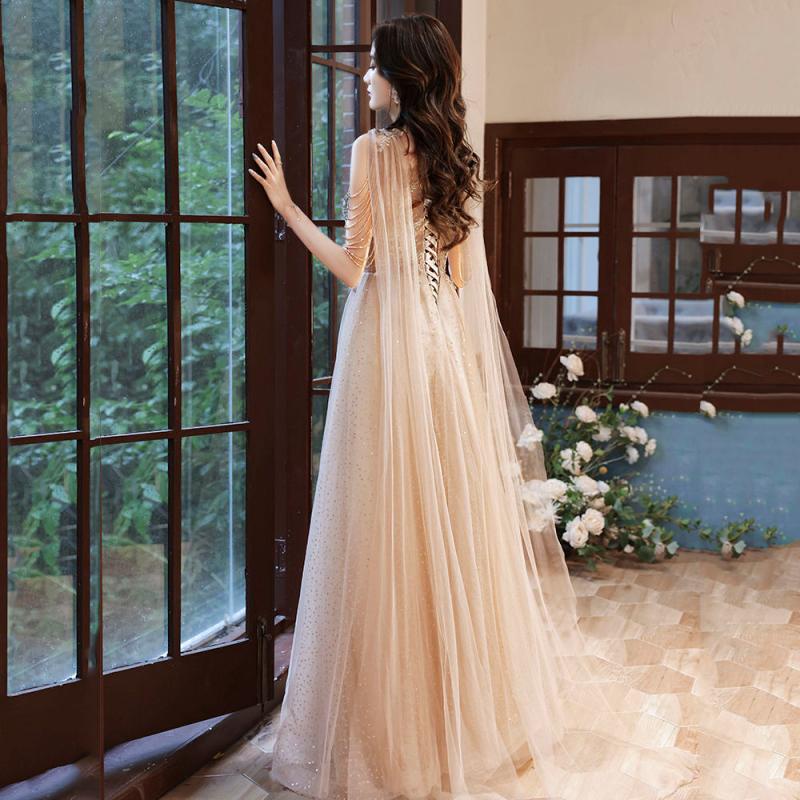 kudapy (พรีออเดอร์ 15-30 วัน) ชุดราตรีไปงาน ชุดราตรียาวคอวีสีทองแชมเปญ แขนปักดีเทลตามแบบ ไหล่ทั้งสองข้างแต่งชายผ้าสามารถผูกเป็นโบว์หรือปล่อยทิ้งเป็นสไบ